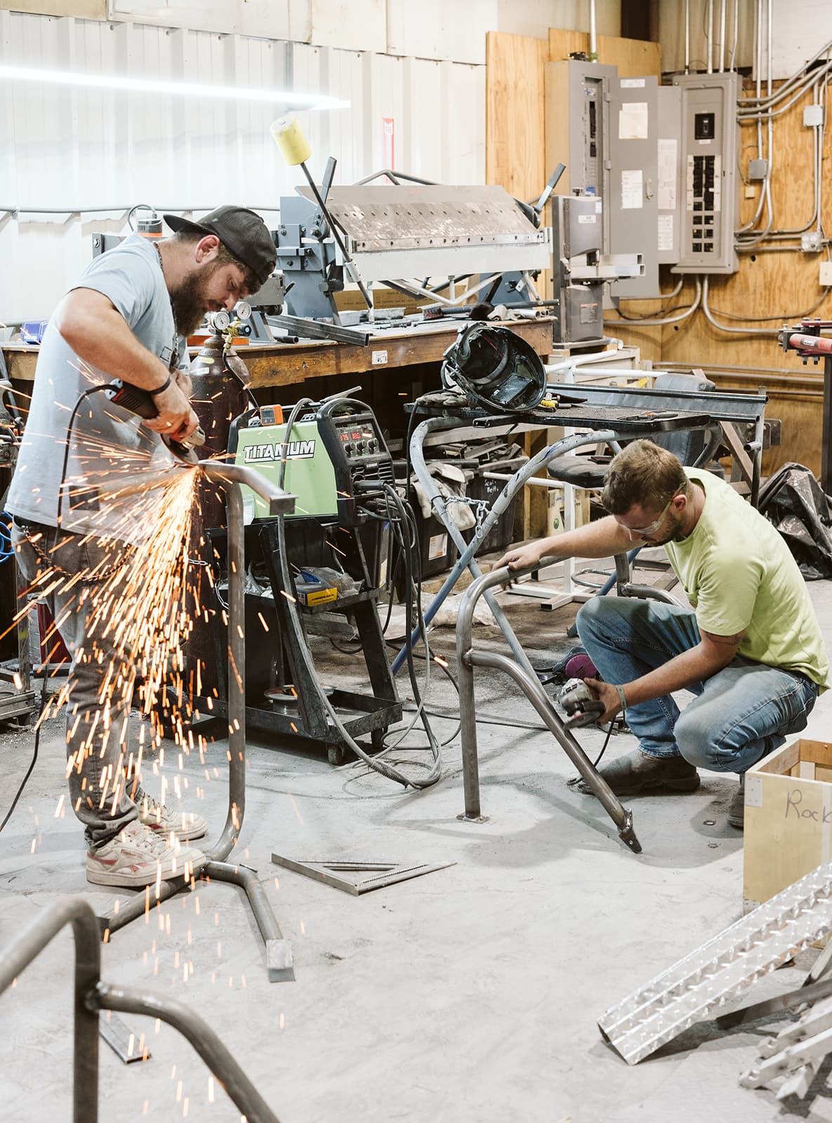 Fabricators welding custom chassis in the Golfin' Garage shop