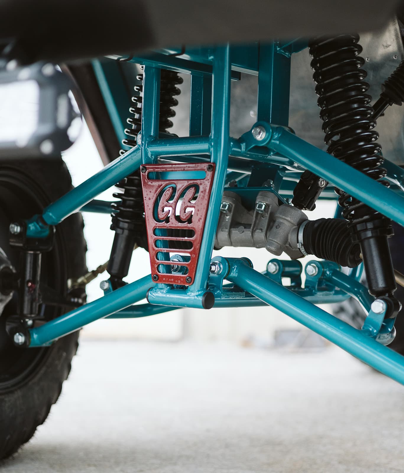 Proprietary GG chassis — teal powder-coated steel frame